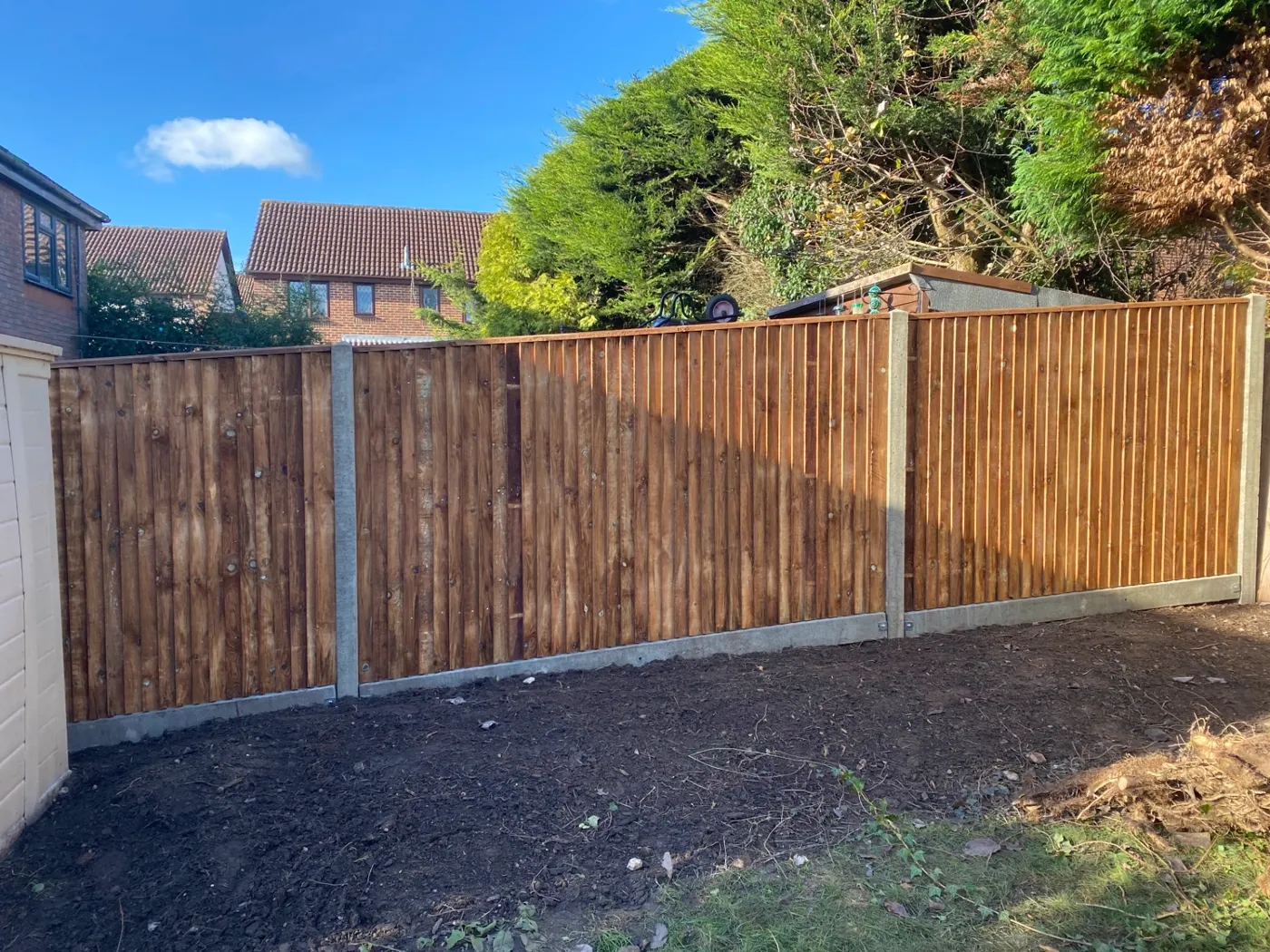 New closeboard fence with concrete posts and gravel boards in a back garden