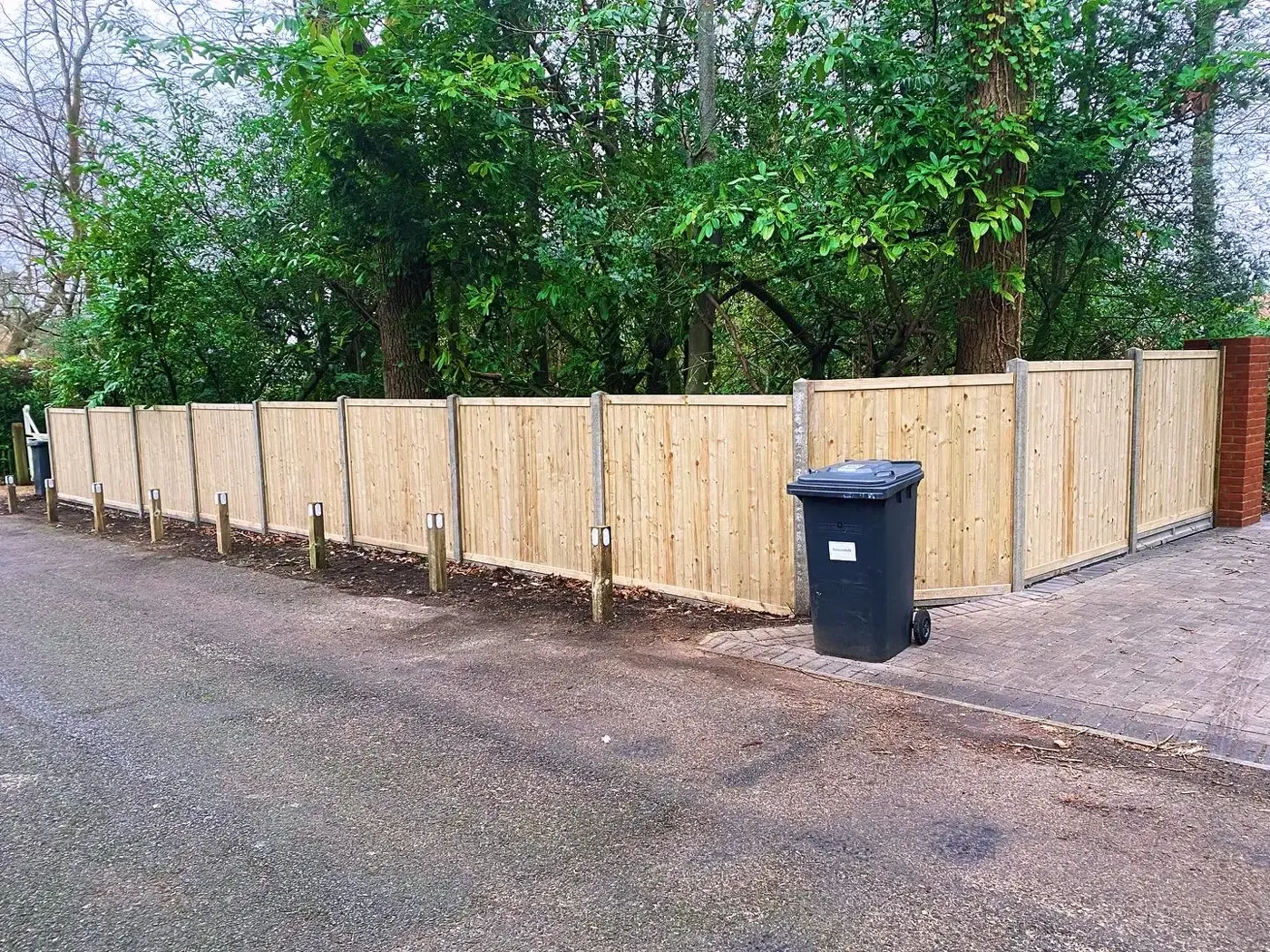 Closeboard fence installation with concrete posts completed in a residential garden