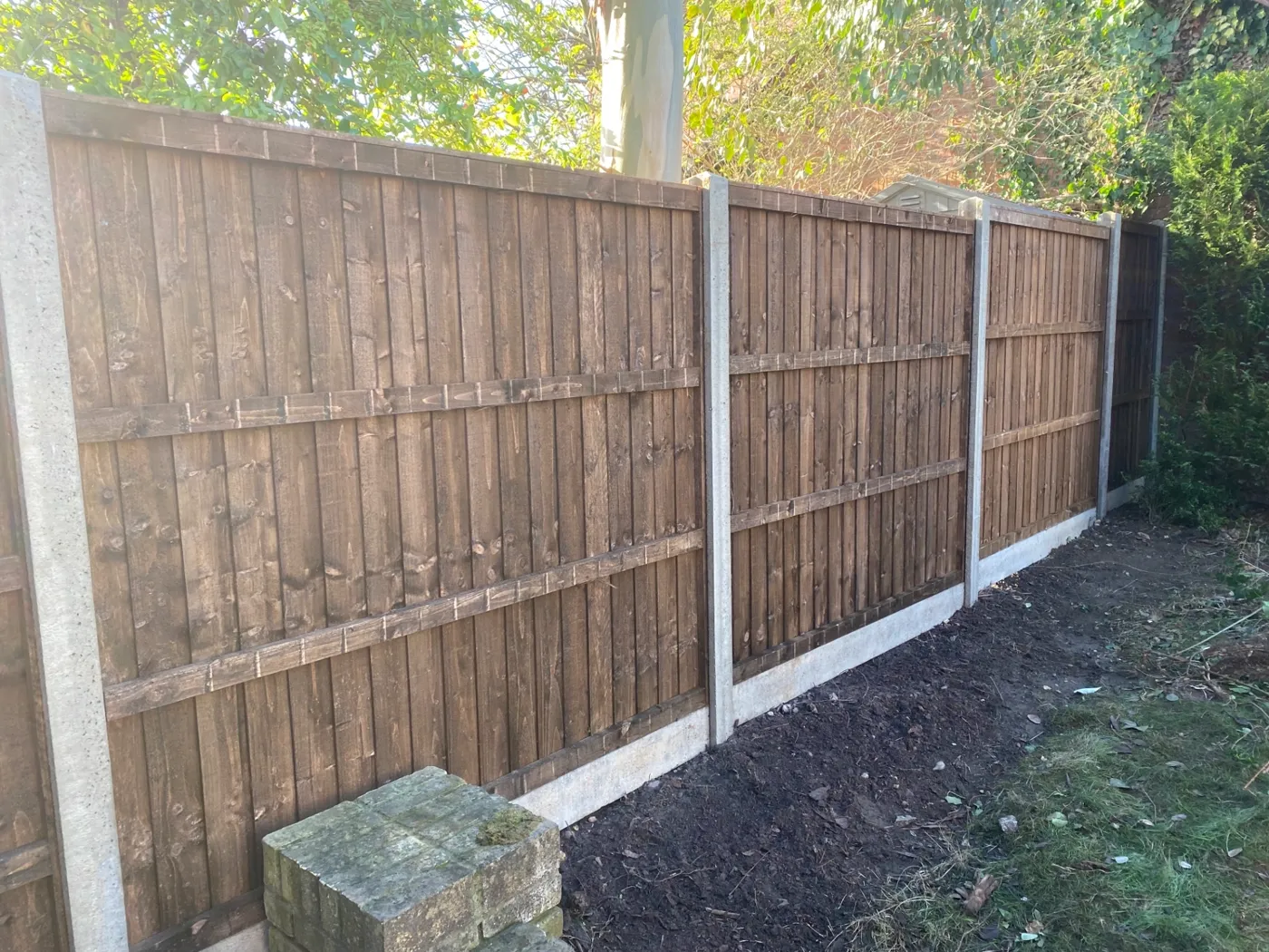 Brown closeboard fence panels fitted with concrete posts and gravel boards